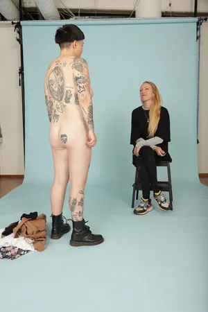 Undress, looking at a queer woman undressing